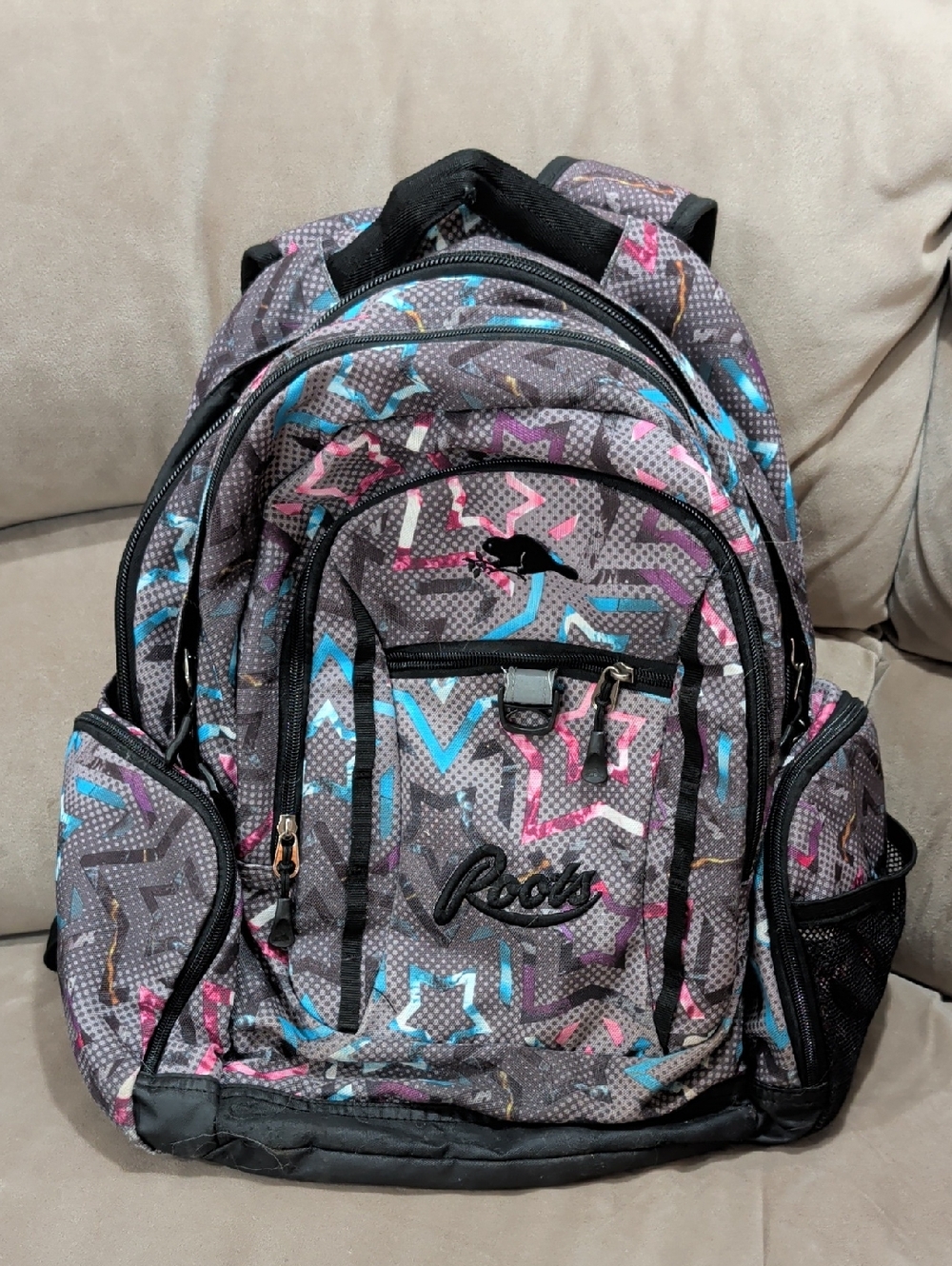 Roots Gray Backpack with Pink and Blue Star Accents